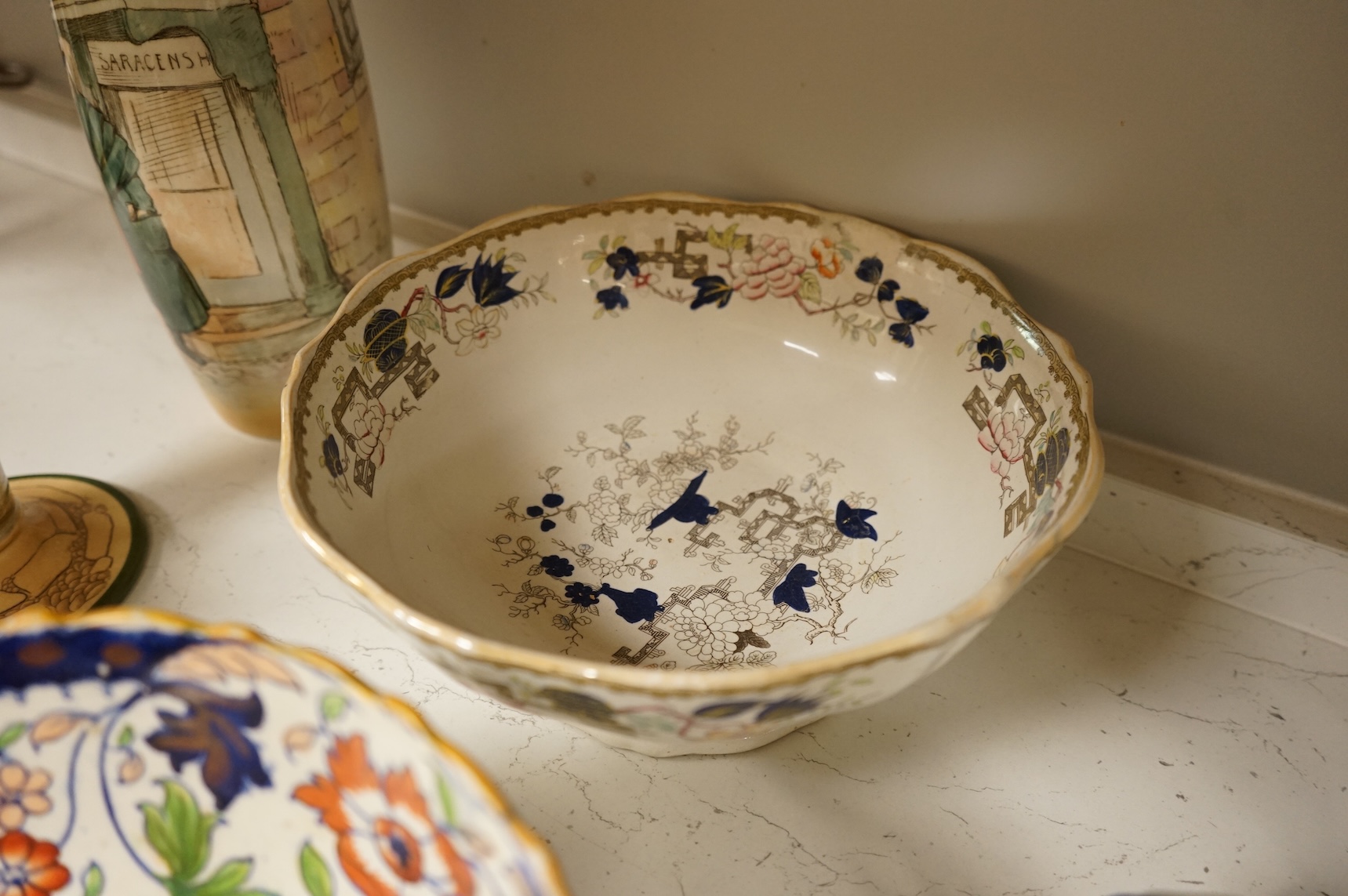 A collection of French, Japanese and English ceramics to include Royal Doulton Dickensware, Imari bowls and a faience glazed cat